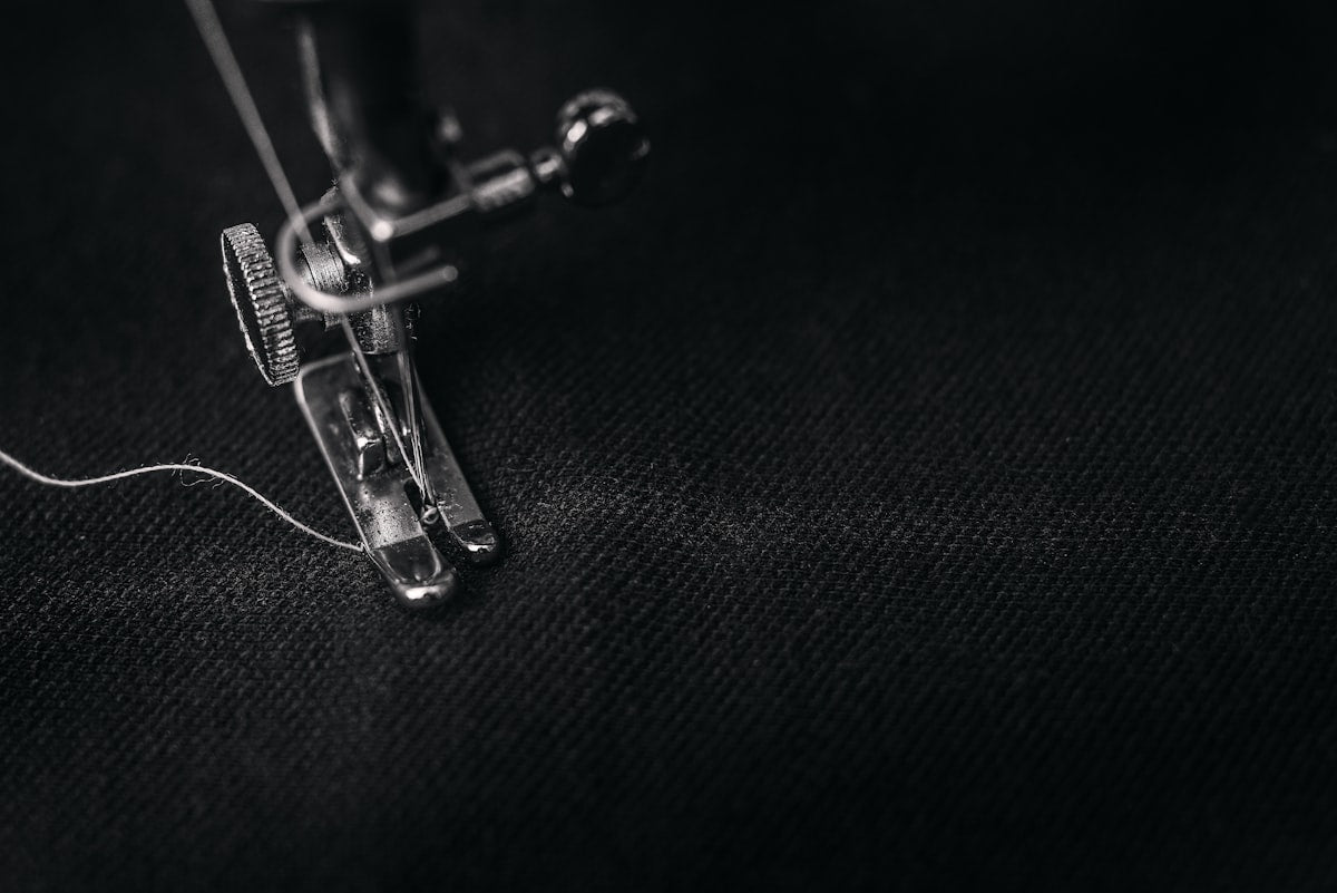 Sewing machine foot with thread close-up