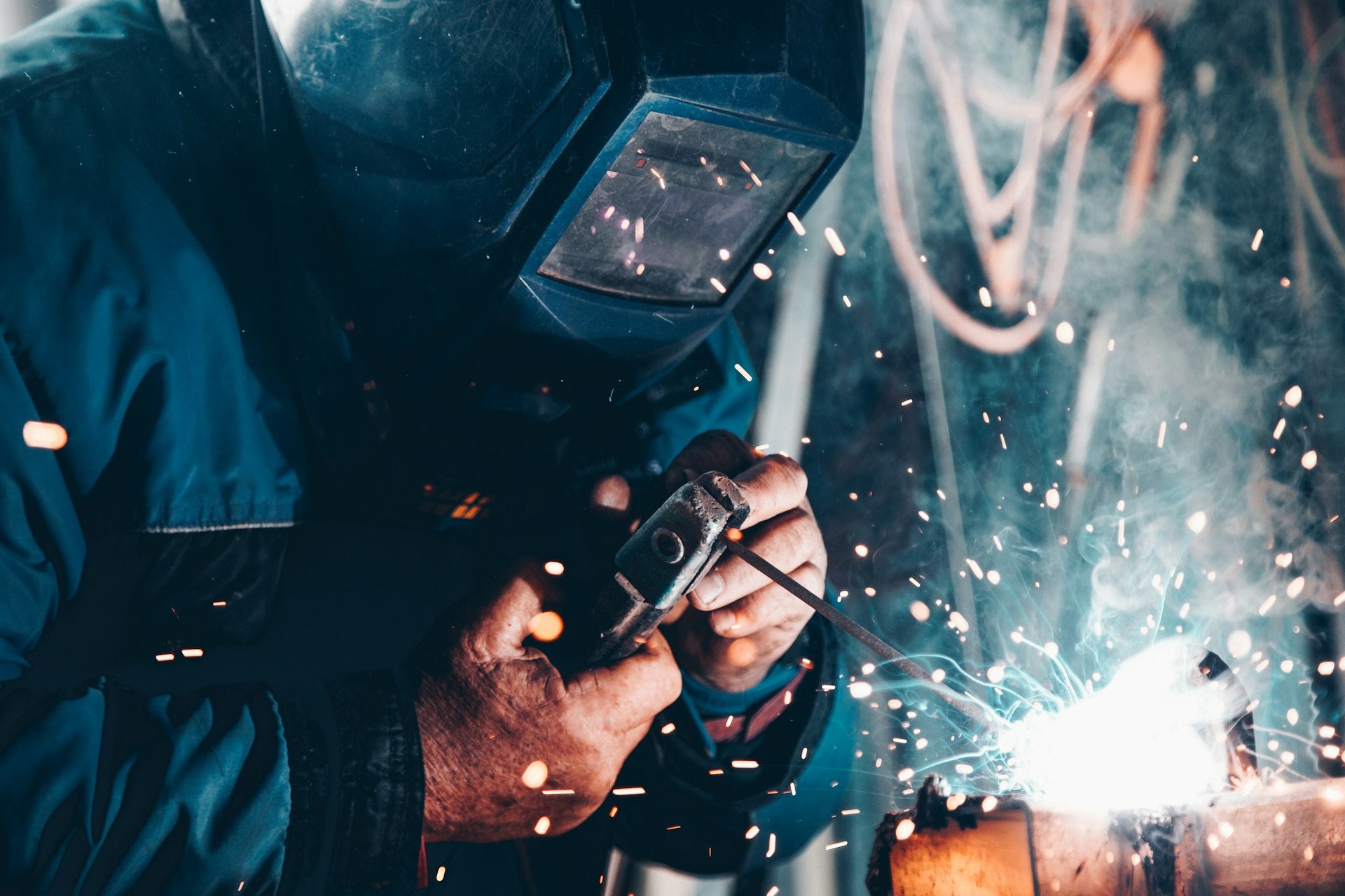 Welding sparks blue collar work